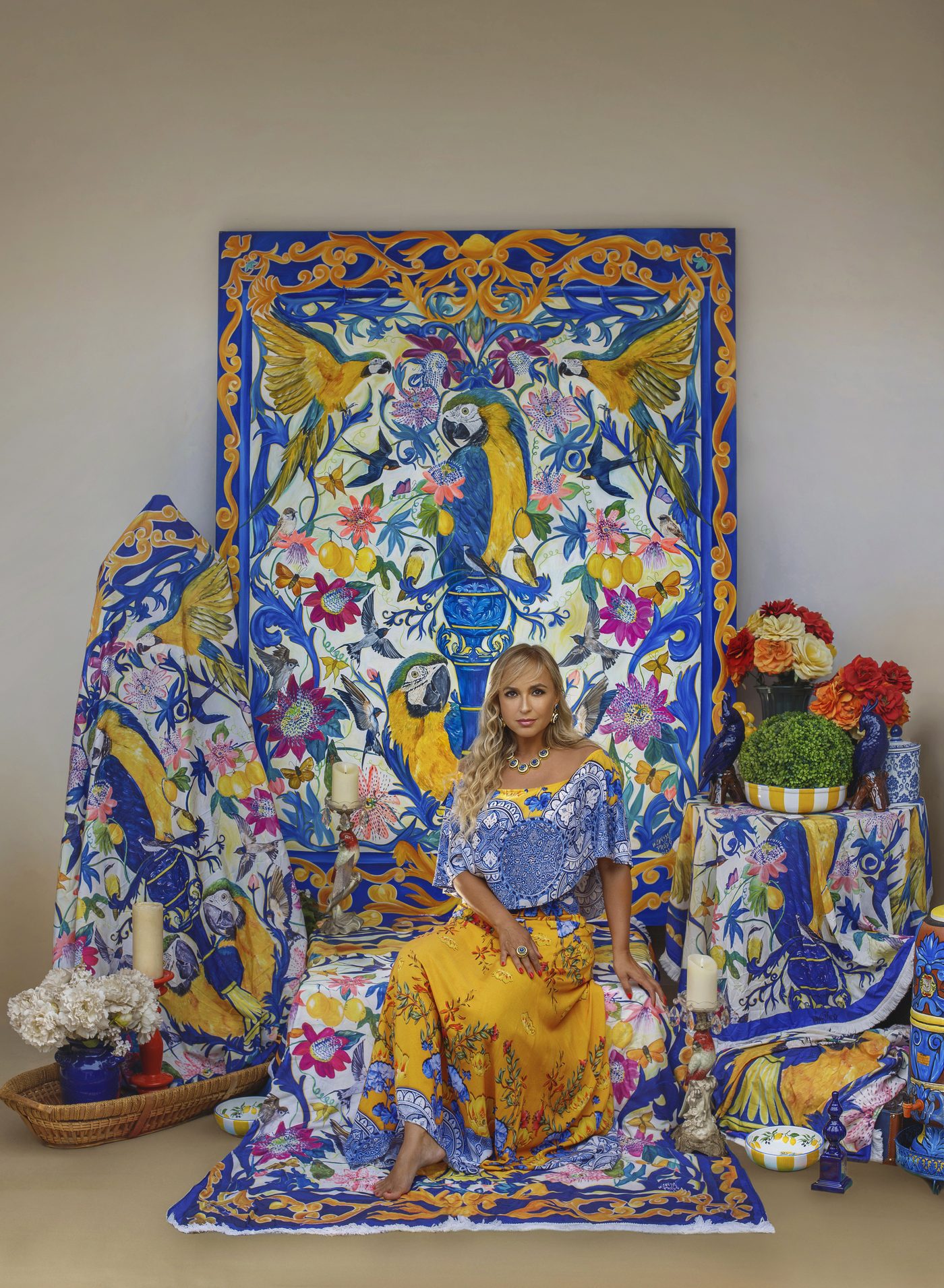 Wanessa Prado diante de obra e têxteis da série Mistura Brasileira